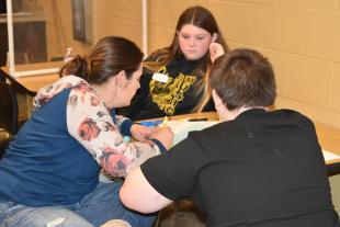 Sarah Kelly, left, completes an exercise with daughter Talyn and son Richard.