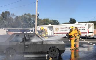 The MU Extension Fire and Rescue Training Institute’s new mobile fire training simulator includes four training props. A trailer, seen in background, allows the institute to conduct realistic, hands-on training courses throughout the state.MU FRTI