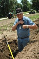 Bellflower, Mo., farmer Russel Winter uses his phone to track weather and the markets while helping trench a ditch for subsurface drip irrigation. Photo by Linda Geist.